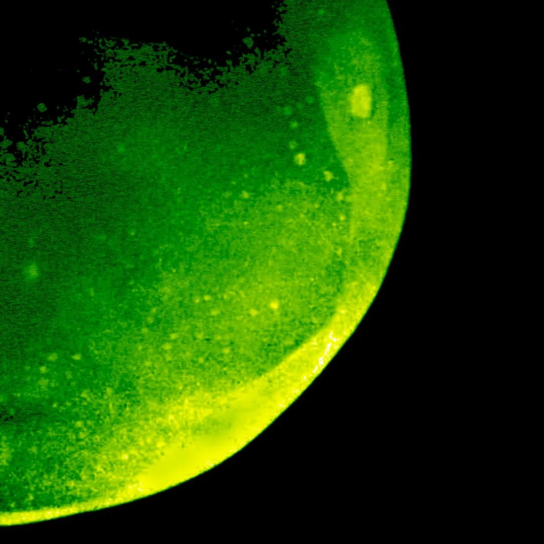 A green stylized version of the trinity explosion.
